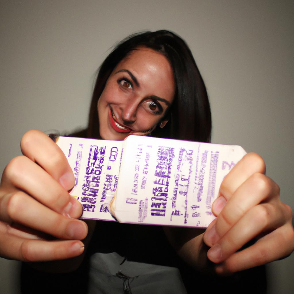 Person holding movie tickets, smiling